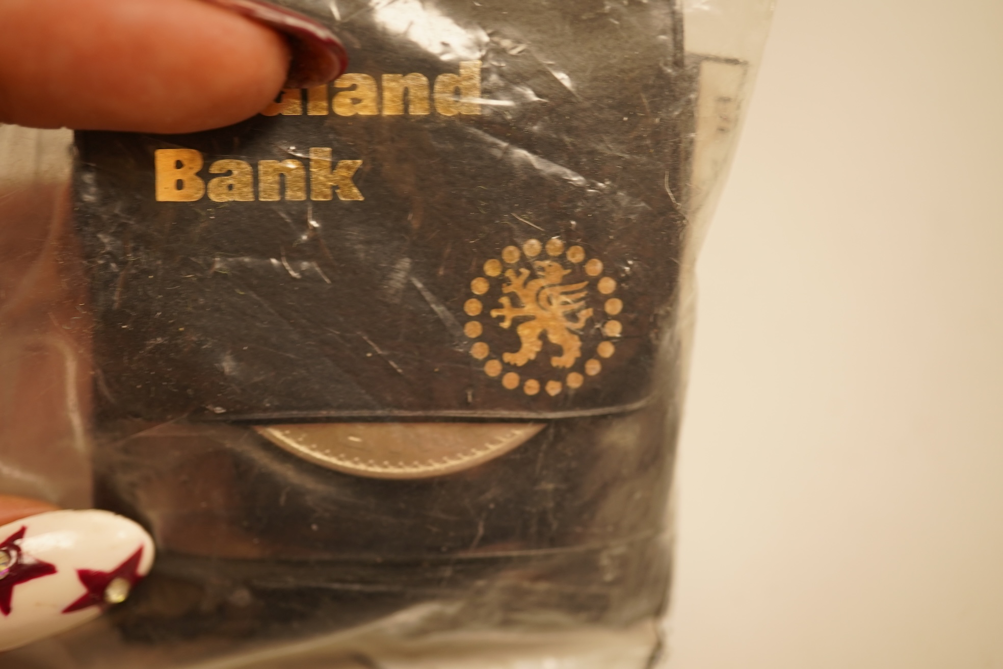 A collection of coins, notes and wrist watches